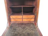 a wooden cabinet with two drawers and a rug on the floor