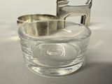 a small glass cup with a silver lid and a horse on it