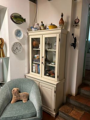 a teddy bear sitting on a chair in a living room