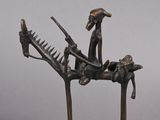 statue of a man on a horse with a gun and a woman sitting on a horse