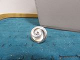 a silver ring sitting on top of a blue carpet