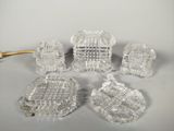 five pieces of glass that are sitting on a table