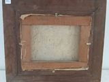 an old picture frame with a piece of wood in the middle of it
