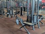 a gym with a lot of machines in the middle of the room