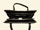 a black purse that is open on a stand
