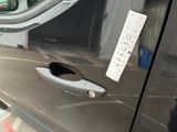 a close up of a car door handle with a sticker on it