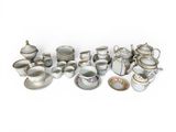 many different types of porcelain dishes and cups on the table