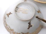 a close up of a cup and saucer on a table