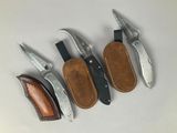 four different types of knives are lined up on a table