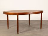 an oval dining table with a wooden top and legs