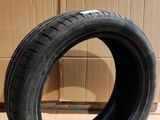 tire on the floor in front of a cardboard box with a cardboard box in the background