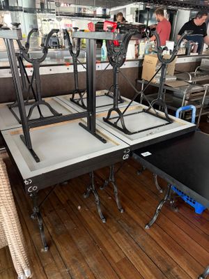 a table that has some chairs on it in a room