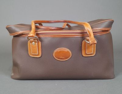 an image of a brown and tan bag on a gray background