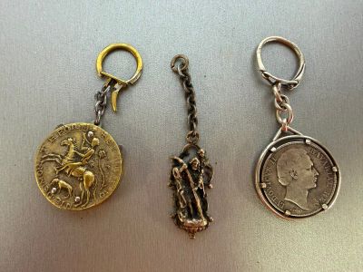 three different types of key chains with a coin on them