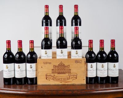 Des bouteilles de vin rouge sont alignées sur une table, à côté d'une caisse en bois