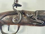 an old gun that is on display on a wall