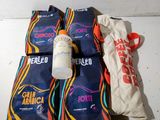 four bags of food and a bottle of water on a table