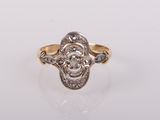 a gold and diamond ring with an old cut diamond in the center