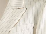 the back of a white suit with pinstripe on it