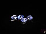 three blue sapphires on a black background