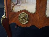 a wooden cabinet with a mirror on top of it