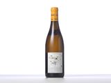 a bottle of white wine sitting on top of a table