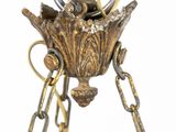 a bird that is sitting in a bird nest on a chain