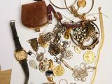 a pile of jewelry on a table next to a piece of paper