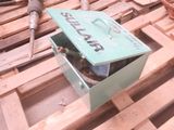 a green box with a sign on it sitting on a pallet