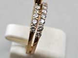 a close up of a gold engagement ring with a white diamond