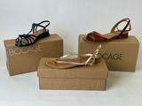 three pairs of women ' s shoes in boxes on a white surface