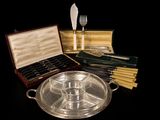 a silver tray with a knife, fork and spoons in it