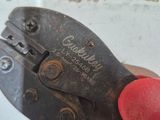someone is holding a pair of pliers in their hand