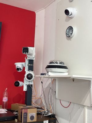 a picture of a room with a red wall and a television