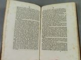 someone is holding a book open to a page with a picture on it