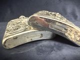 pair of antique silver plated pocket knives on a black background