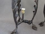 two candles that are sitting on a metal stand