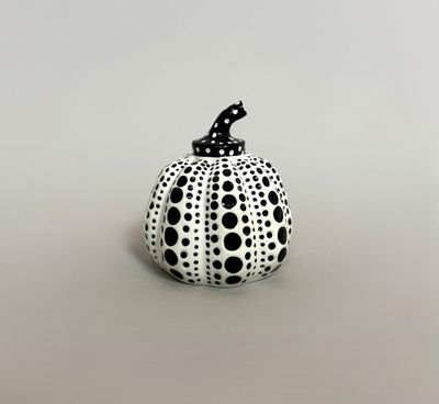 black and white polka dot pumpkin with a black cat on top