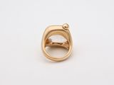 a close up of a gold ring on a white surface