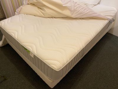 a bed with a mattress and a blanket on it