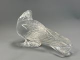 clear glass figurine of a bird sitting on a branch