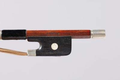 a violin bow that is attached to a piece of wood