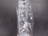 an empty plastic bottle sitting on top of a black table