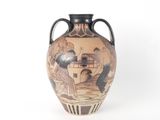 a vase with a painting on it sitting on a table