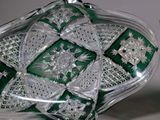 pair of green and white glass vases on a white surface