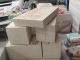 a truck parked in a garage next to a pile of boxes