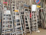 a lot of chairs and ladders in a warehouse