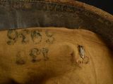 a close up of a brown hat with writing on it