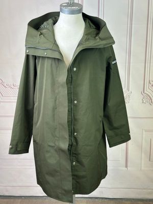 an image of a green rain coat on a mannequin mannequin