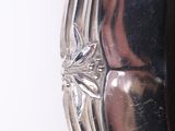 a mirror that is on the wall with a silver frame